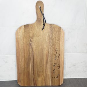 Children's handwriting on a chopping board