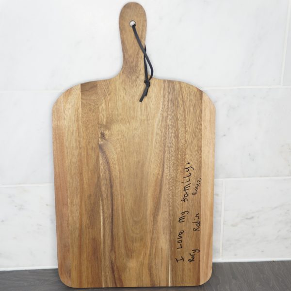 Children's handwriting on a chopping board